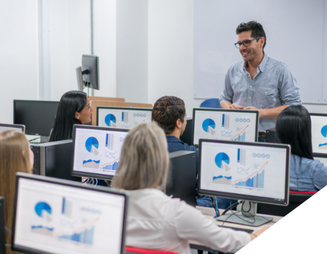 a man presenting to a class of adult students using computers