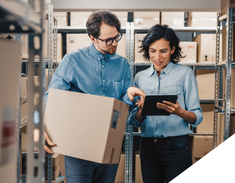 a man and woman in a warehouse using a tablet