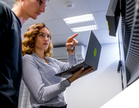 A woman showing a man something on a computer screen
