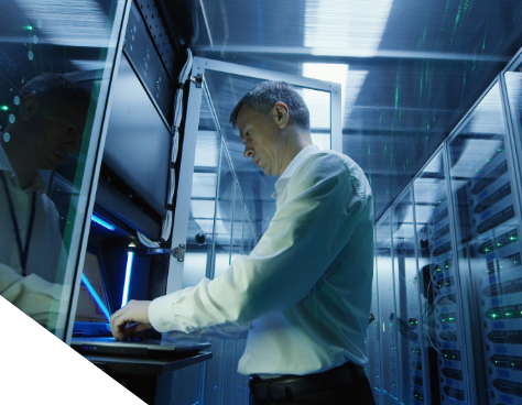 A photo of a man working at a server rack station